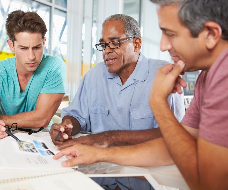 group-of-men-meeting-in-creative-office-PXEKFW4-780x650